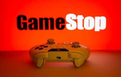 Dhaka, Bangladesh- 15 July 2025: Game controller in front of GameStop logo on a background