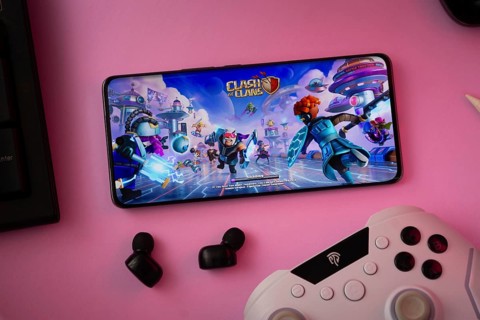 Dhaka, Bangladesh- 15 July 2025: A close-up of a gamepad with the Clash of clans seen on smartphone