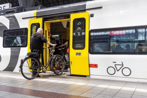 Platform with travellers and bicycles in front of the bicycle compartment. Central station with