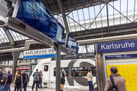 Platform with travellers at Karlsruhe main station with S-Bahn. Karlsruhe, Baden-Württemberg,
