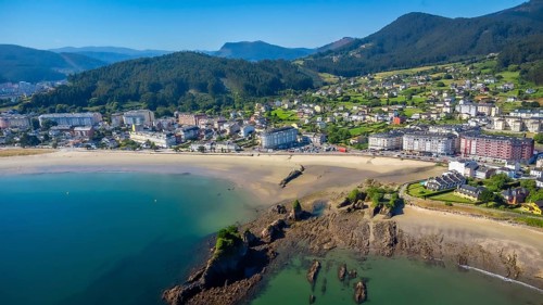 Aerial view of covas beach meeting the charming town of viveiro, nestled amidst the stunning