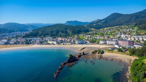 Aerial view of covas beach meeting the charming town of viveiro, nestled amidst the stunning
