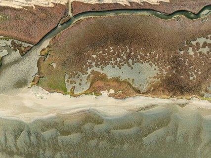 Marshes and streams at low tide in the Walvis Bay Lagoon. Aerial view. Drone shot. Namibia