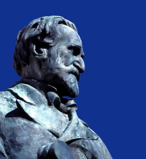 Verdi monument in front of Rocca dei Marchesi Pallavicino, now the city hall, with Teatro Giuseppe