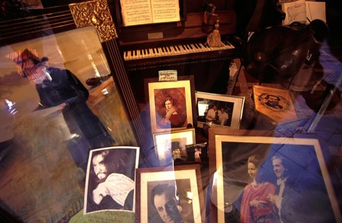 Shop window decoration in honor of Giuseppe Verdi, with pictures of opera Opera singer and