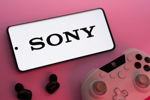 Dhaka, Bangladesh- 02 July 2025: Smartphone with sony logo, game controller, and earbuds on a pink