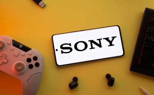 Dhaka, Bangladesh- 03 June 2025: Smartphone with Sony logo, game controller, and earbuds on a