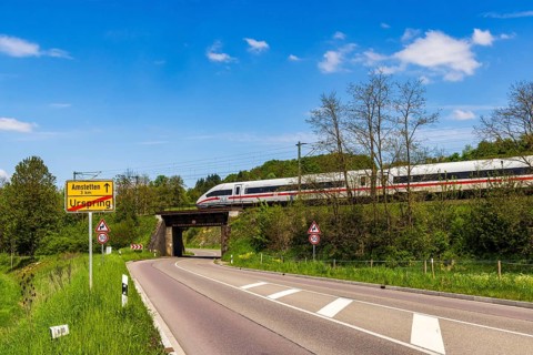 InterCityExpress ICE en route on the Swabian Alb near Lonsee. Landscape with railway bridge near