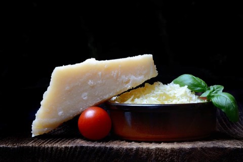 Parmesan cheese, grated cheese in rind and piece of Parmesan, Italy