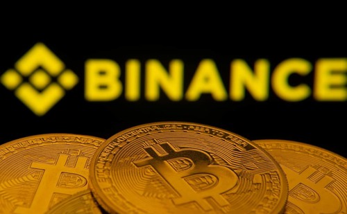 Dhaka, Bangladesh- 22 June 2025: Close-up of Bitcoin coins with the Binance logo visible on a