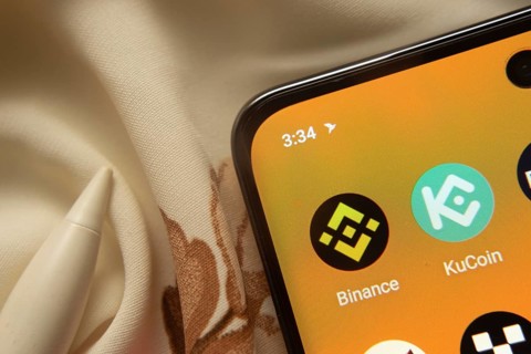 Dhaka, Bangladesh- 07 May 2025: Binance and KuCoin app icon is seen on smartphone