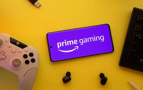 Dhaka, Bangladesh- 22 June 2025: Smartphone with prime gaming logo, game controller, and earbuds on