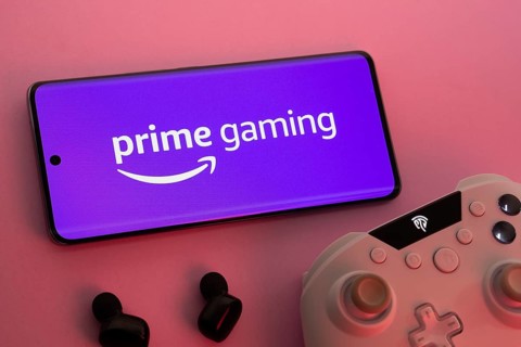 Dhaka, Bangladesh- 22 June 2025: Smartphone with prime gaming logo, game controller, and earbuds on