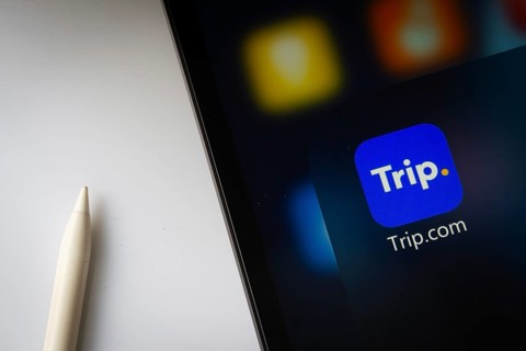 A close up of an iPad screen displaying the trip.com app