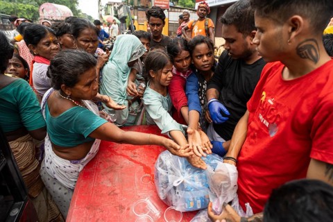 Devotees throng to have food as they arrives to visit Kamakhya Temple during Ambubachi Mela, in