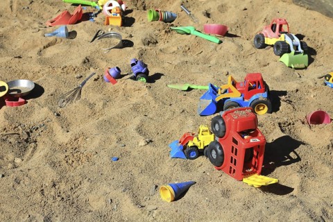 Playground, sandpit with plastic toys, vehicles, shovel