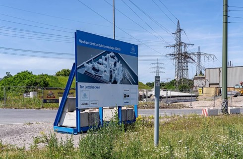 Construction site sign for thyssenkrupp Steel's first direct reduction plant, the climate-neutral