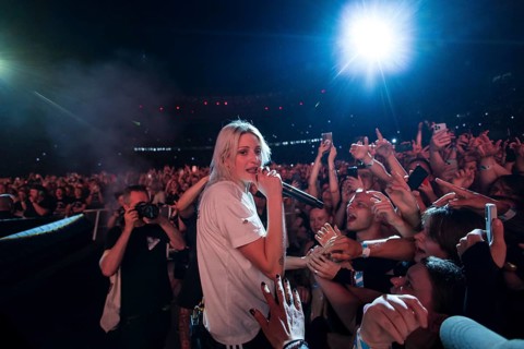 Emily Armstrong, lead singer of Linkin Park in the photo pit between the audience live on From Zero