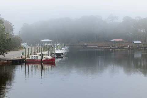 Private fishing boats in the harbor at Ocean Springs, Mississippi on a foggy morning