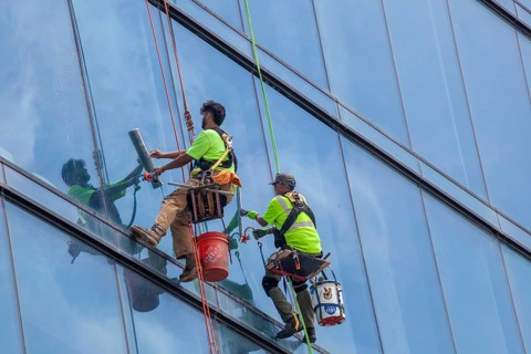 Detroit, Michigan - Window washers at the 25-story Residences Water Square luxury apartment