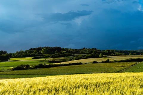 Dramatic cloudy sky with approaching storm and last rays of sunshine, Frankenhain, dark cloud wall,