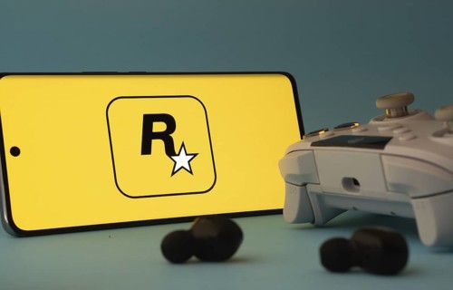 Dhaka, Bangladesh- 17 June 2025: A smartphone with a rockstar games app icon next to a controller