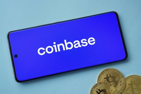 Dhaka, Bangladesh- 17 June 2025: Smartphone displaying Coinbase logo with Bitcoin coins on a blue
