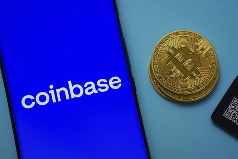 Dhaka, Bangladesh- 16 June 2025: Coinbase logo on smartphone screen near Bitcoin coin and QR code