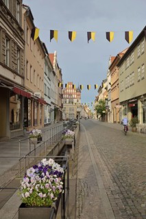 Historic pipe water in the Schlossstraße with flower decoration and houses, sewage, water pipe,
