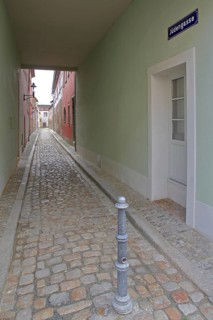 Narrow alley with houses, passage, subway, long narrow, alleyway with cobblestones and vanishing