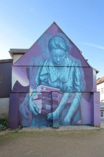 Mural Knowledge by Sokar Uno 2023, blue violet house wall, woman carrying a stack of books, books,