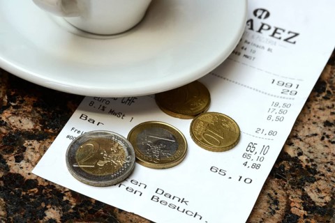 Tip, euro coins with receipt