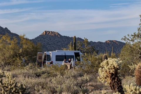 Camper van parked at a desert campsite at the White Tank Mountain Regional Park campground in