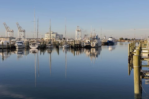 Sailboats and fishing boats docked in the Small Craft Harbor at Gulfport, Mississippi, USA