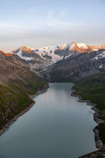 View at the summit of Mont de la Blana, alpenglow at sunset, view of a blue mountain lake, Lac des