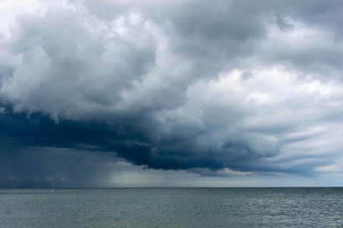 Thick, dark rain clouds gather over the Baltic Sea, Prerow, Mecklenburg-Vorpommern, Germany