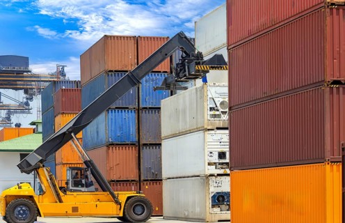 Busy international industrial port with freight and shipment docks and cargo containers