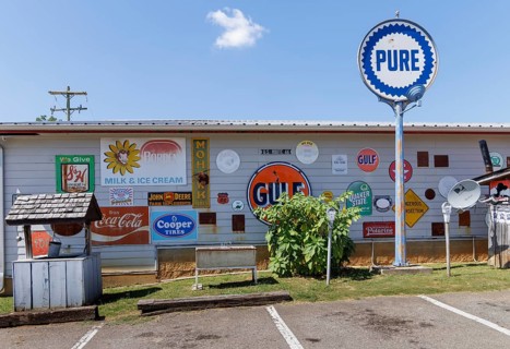 Antique metal advertising signs used for decoration on the side of a building near Counce,