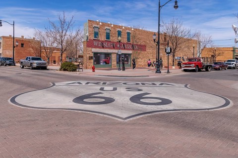 Tourists take photos Standin' on a Corner in Winslow Arizona as sung in the classic Glenn Frey and