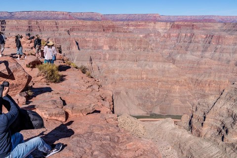 Tourists on the edge of the canyon at Guano Point area of Grand Canyon West near Peach Springs,