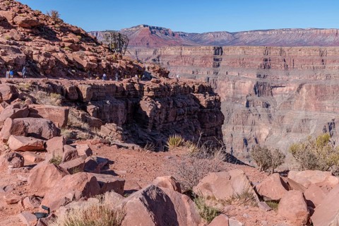 Visitors walk along the canyon rim to the location of the old mining cable structure at Guano Point