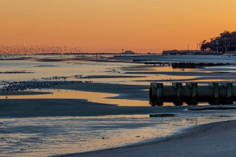 Sunset on the Mississippi Sound along the coastline of Long Beach, Mississippi, USA