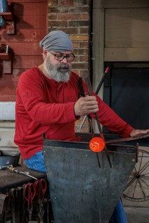 Glass blower demonstrates the art of blowing glass at the Dollywood amusement park in Pigeon Forge,