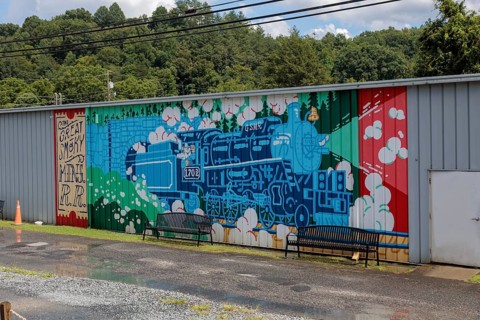 Mural on the back of a building welcomes Great Smoky Mountains Railroad passengers back to Bryson