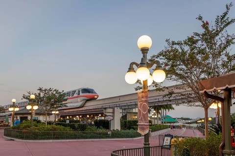 Monorail carries passengers toward the entrance to the Magic Kingdom at Walt Disney World in