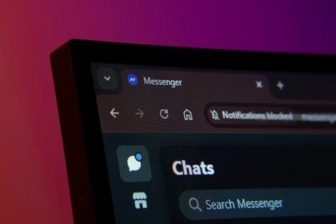 Close-up of a computer screen displaying the Messenger web interface in dark mode