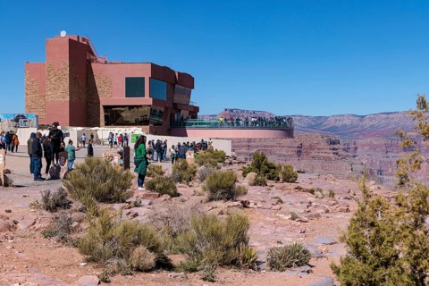 Guests view the canyon from the ground and from the Skybridge, a glass floored bridge overlooking