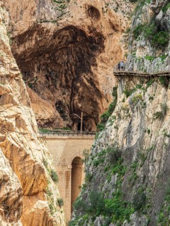 Tourists on the elevated path of the caminito del rey, along a deep gorge, Andalusia, Spain