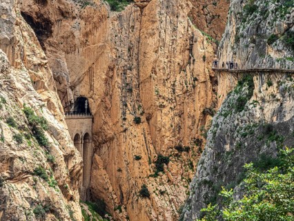 Tourists on the elevated path of the caminito del rey, along a deep gorge, Andalusia, Spain