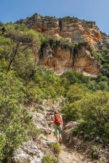 Woman hiking in the corlorful gorge La Garganta Verde, Sierra de Grazalema, Andalusia, Spain